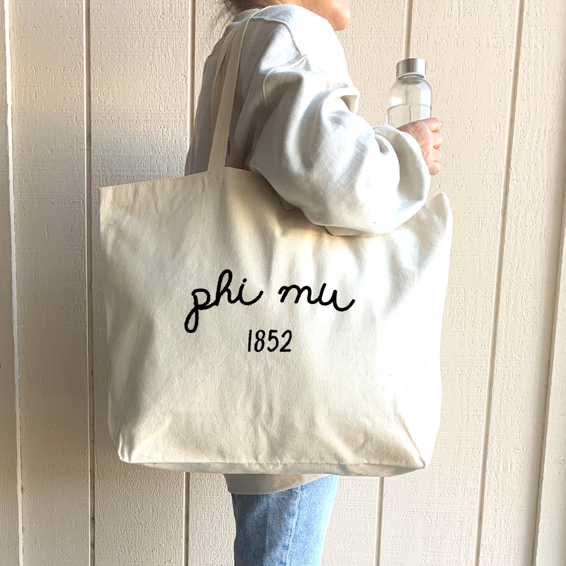 Phi Mu – A stylish college student holds a Phi Mu sorority tote, ideal for class, errands, or sisterhood events.