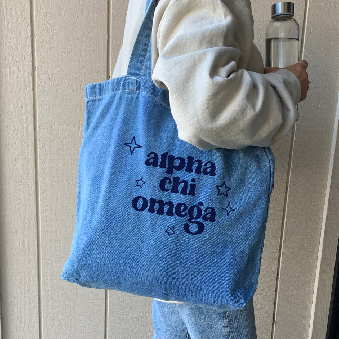 Alpha Chi Omega denim blue tote bag shown on model