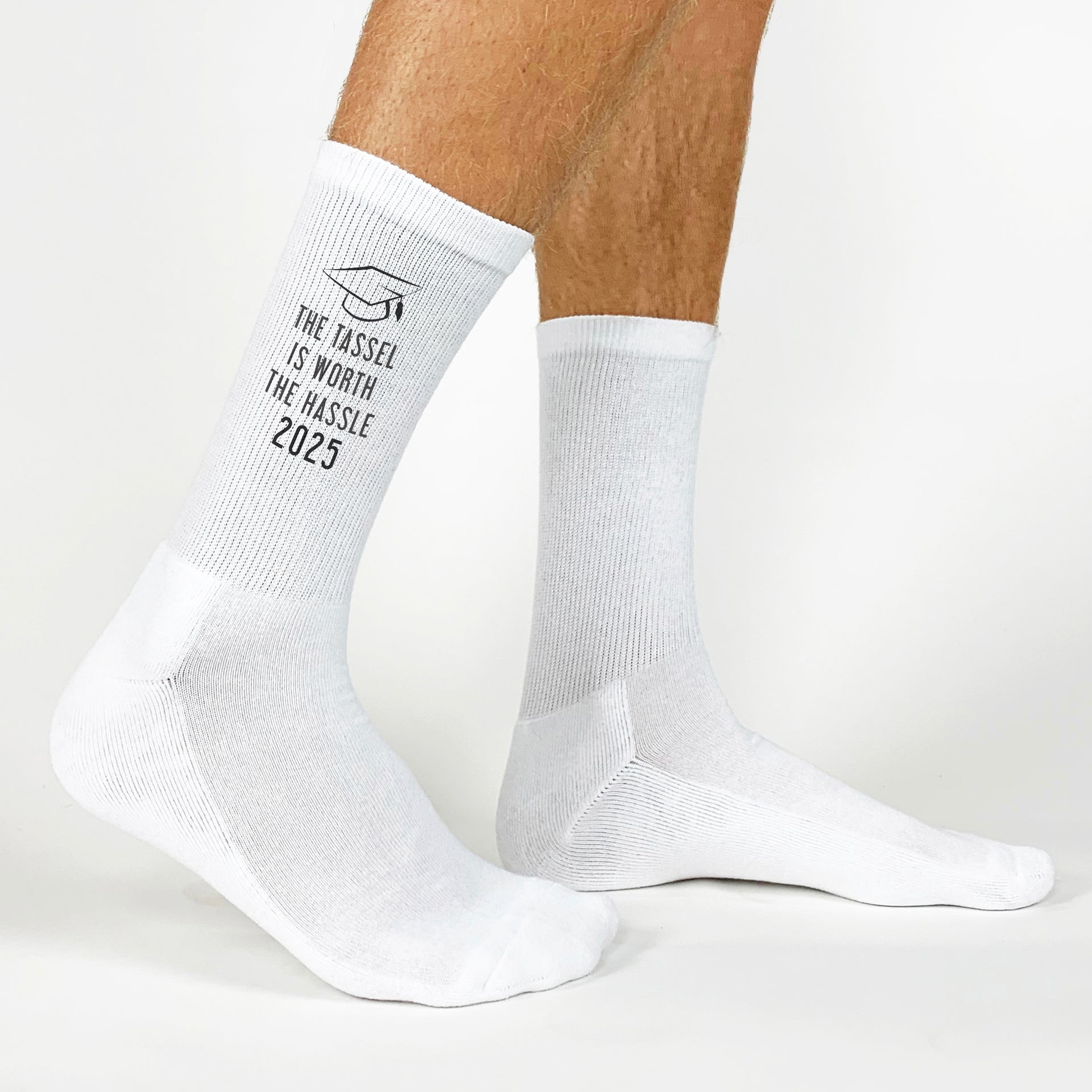 Funny 'The Tassel is Worth the Hassle' socks for 2025 graduates to wear on their special day.