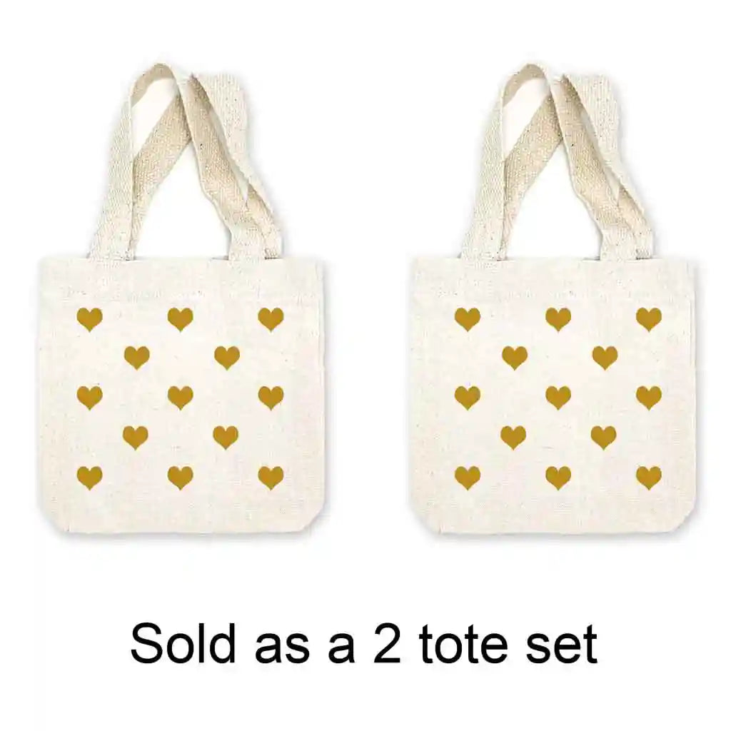 Mini canvas tote bags with all over heart design digitally printed in the color of your choice sold in a pack of four. 