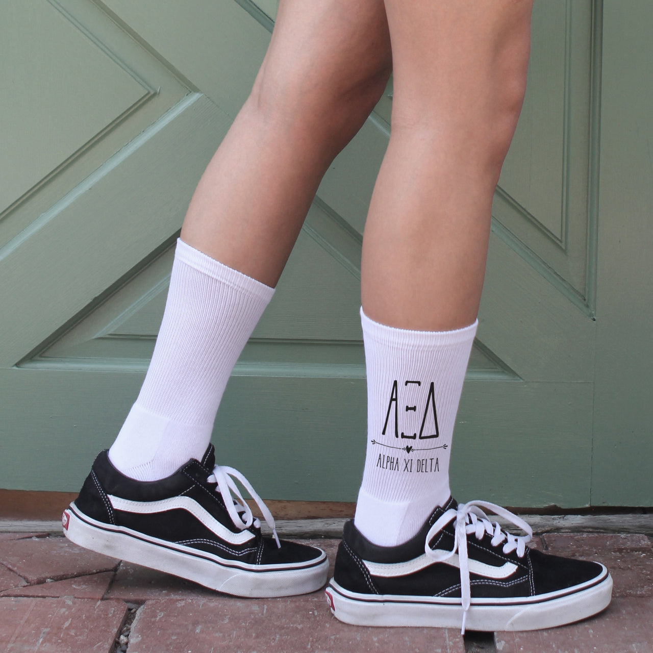 Alpha Xi Delta white boho print socks with sorority letters worn by college student